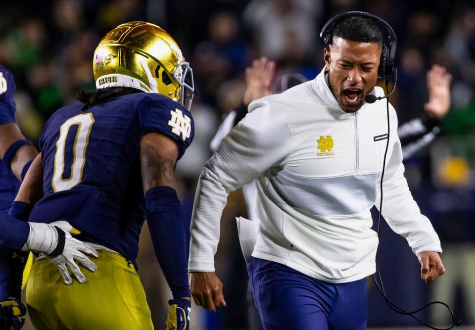 Notre Dame head coach Marcus Freeman celebrates with safety Xavier Watts (0) during the second half of an NCAA college football game against Southern California Saturday, Oct. 14, 2023, in South Bend, Ind. (AP Photo/Michael Caterina)