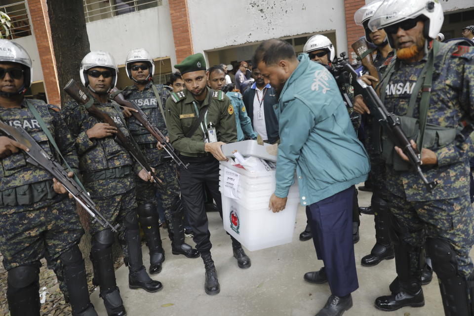 Security officers carry ballot boxes for distribution in Dhaka, Bangladesh,Saturday, Jan. 6, 2024. An apparent arson fire on a train in Bangladesh’s capital killed four people late Friday and added to the country’s extreme tension ahead of Sunday’s parliamentary elections that the opposition is seeking to boycott and disrupt with a general strike. (AP Photo/Mahmud Hossain Opu)