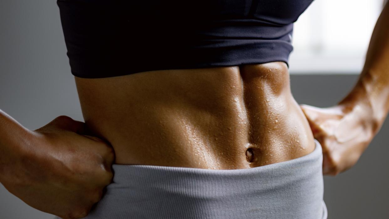  A photo of a woman with strong abs. 
