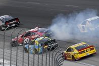 Christopher Bell (20) spins coming out of Turn 2 in front of Austin Dillon (3) and Joey Logano (20) during the NASCAR Cup Series All-Star auto race at Texas Motor Speedway in Fort Worth, Texas, Sunday, June 13, 2021. (AP Photo/Larry Papke)