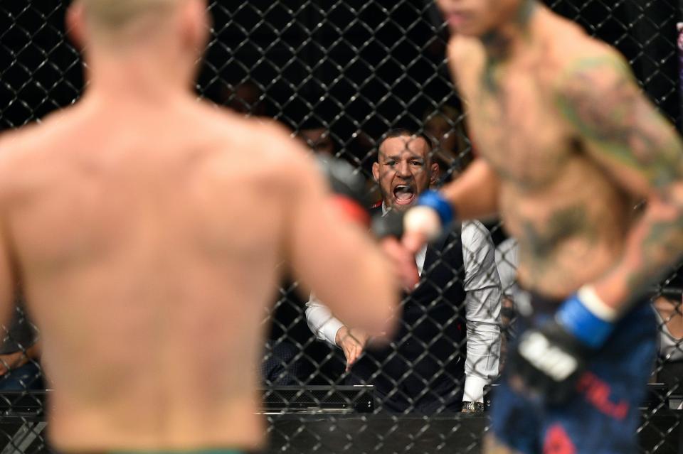 Conor McGregor cheers on Artem Lobov during one fight..jpg