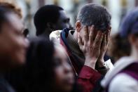 A mourner reacts during a candlelight vigil in the aftermath of Monday's Boston Marathon explosions, which killed at least three and injured more than 140, Wednesday, April 17, 2013, at City Hall in Cambridge, Mass. (AP Photo/Matt Rourke)