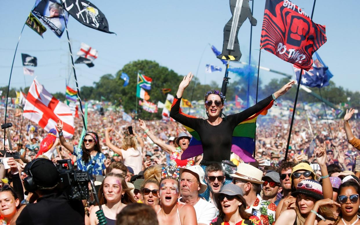 Revelers at the Pyramid Stage, Glastonbury, 2019 - HENRY NICHOLLS