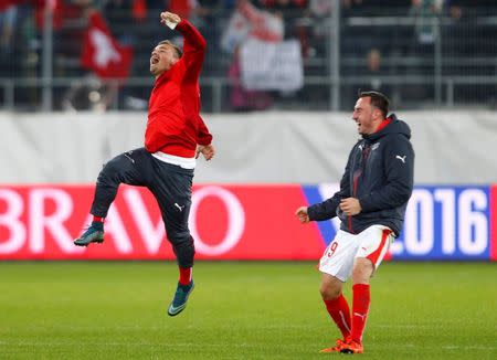 Switzerland's Xherdan Shaquiri (L) celebrates with team mate Josip Drmic after defeating San Marino and qualifying for the Euro after their Euro 2016 Group E qualifying soccer match in St. Gallen, Switzerland October 9, 2015. REUTERS/Arnd Wiegmann