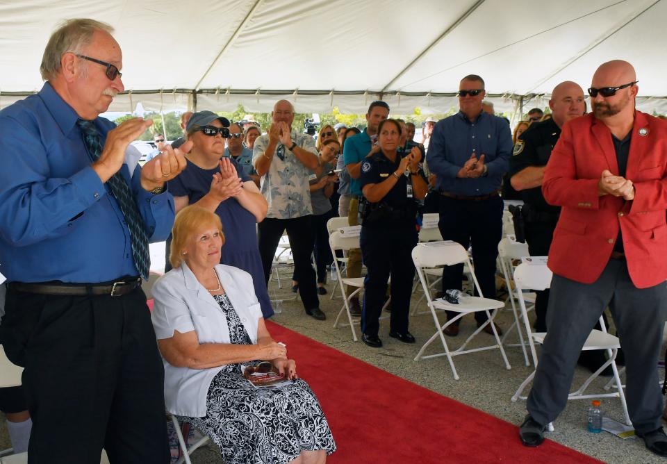 Fallen Melbourne Police Officer Joseph Pellicano's widow, Marion, seen seated, receives a standing ovation during Wednesday's event.