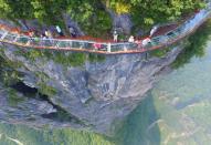 <p>Visitors stroll across a glass skywalk nearly 1000 feet up, located on Panlong Cliff in China // August 1, 2016</p><p><strong>RELATED: </strong><a href="https://www.redbookmag.com/life/news/g3773/best-travel-apps-trip-planner/" rel="nofollow noopener" target="_blank" data-ylk="slk:11 Apps That Take the Stress Out of Vacation Planning;elm:context_link;itc:0;sec:content-canvas" class="link "><strong>11 Apps That Take the Stress Out of Vacation Planning</strong></a></p>