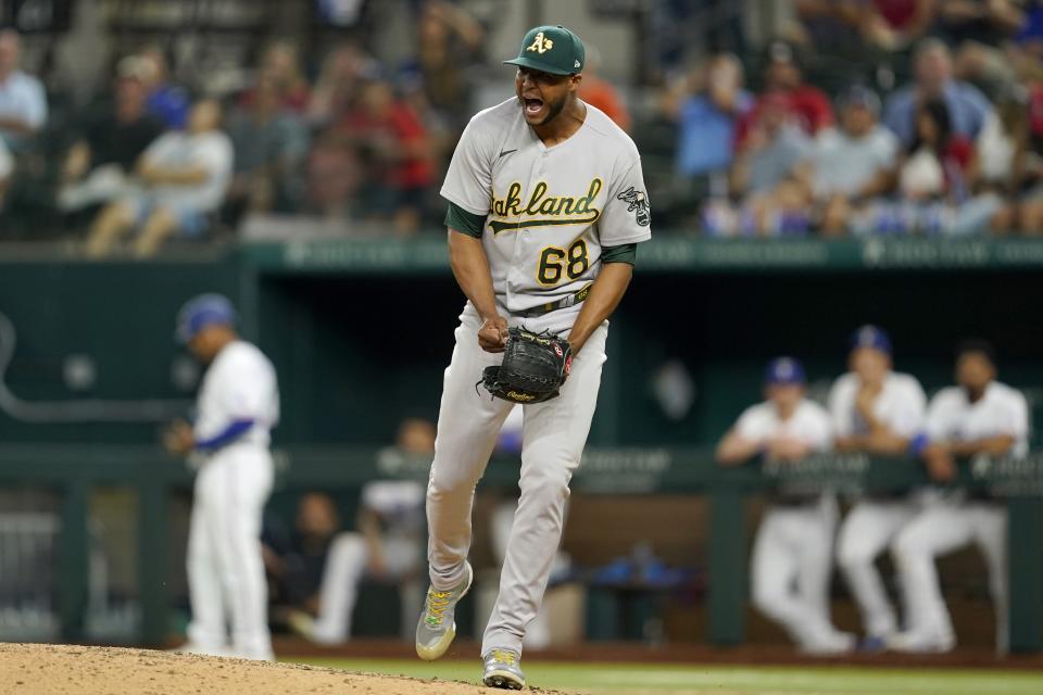 Oakland Athletics relief pitcher Domingo Acevedo celebrates getting the final out in the team's 8-7 win in a baseball game against the Texas Rangers in Arlington, Texas, Wednesday, Sept. 14, 2022. (AP Photo/Tony Gutierrez)