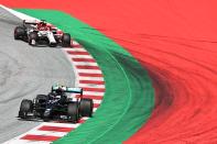 Mercedes' Finnish driver Valtteri Bottas (L) and Alfa Romeo's Finnish driver Kimi Raikkonen steer their cars during the Formula One Styrian Grand Prix race on July 12, 2020 in Spielberg, Austria. (Photo by Joe Klamar / various sources / AFP) (Photo by JOE KLAMAR/AFP via Getty Images)