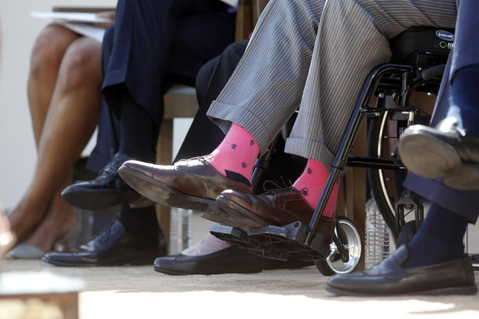 Former President George H.W. Bush wears pink socks as he is seated in a wheelchair with, from left, first lady Michelle Obama, President Barack Obama, former first lady Barbara Bush, and former President George W. Bush, at the dedication of the George W. Bush presidential library on the campus of Southern Methodist University in Dallas on Thursday, April 25, 2013. (AP Photo/Charles Dharapak)