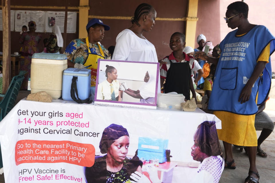 Health workers talk with a girl before administering a cervical cancer vaccine HPV Gardasil to her at a health centre in Ibadan, Nigeria, on May 27, 2024. African countries have some of the world's highest rates of cervical cancer. Growing efforts to vaccinate more young girls for the human papillomavirus are challenged by the kind of vaccine hesitancy seen for some other diseases. Misinformation can include mistaken rumors that girls won't be able to have children in the future. Some religious communities must be told that the vaccine is "not ungodly." More than half of Africa's 54 nations – 28 – have introduced the vaccine in their immunization programs, but only five have reached the 90% coverage that the continent hopes to achieve by 2030. (AP Photo/Sunday Alamba)