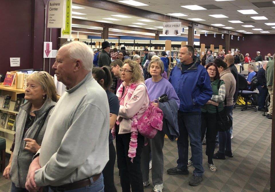 People wait in line for at an early caucus site at the Sparks Library, Saturday, Feb. 15, 2020 in Sparks, Nev. More than 300 people were waiting in a line that snaked through aisles of book shelves at the library. Dozens left without voting. “Turnout is much bigger than we expected,” Sparks site leader Carissa Snedeker said. (AP Photo/Scott Sonner)
