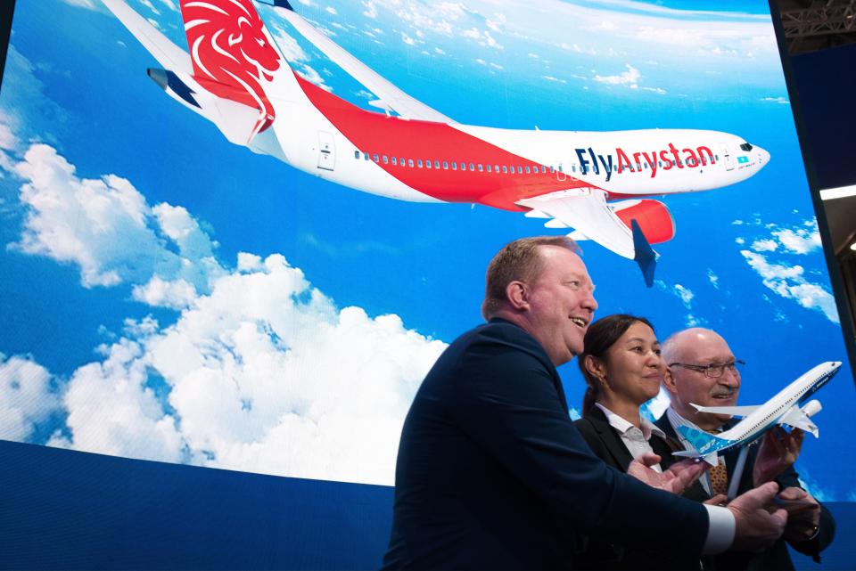 From left; Boeing Commercial Airplanes president and CEO Stanley A. Deal, Air Astana chief planning officer Alma Aliguzhinova and Air Astana chief operating officer Anthony Regan pose after a news conference at the Dubai Airshow in Dubai, United Arab Emirates, Tuesday, Nov. 19, 2019. Kazakhstan's national carrier Air Astana announced Tuesday a letter of intent to purchase 30 of Boeing's 737-8 Max jets for its new budget airliner FlyArystan. (AP Photo/Jon Gambrell)