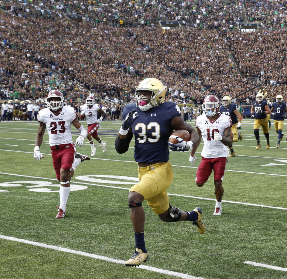 Notre Dame running back Josh Adams (33) has seven 100-yard rushing games this season. (AP Photo/Charles Rex Arbogast)