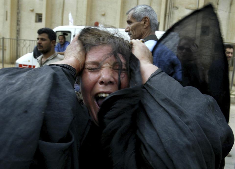 FILE - An Iraqi woman screams upon arriving with her wounded husband and son at al-Kindi hospital, April 8, 2003, in Baghdad. (AP Photo/Jerome Delay, File)