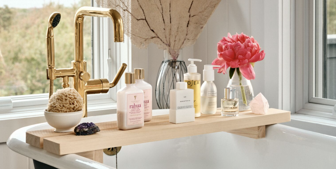 bathroom shelf ideas, a close up of a bath tray over the bath tub with products on top