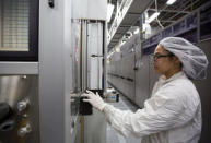 Marie Grace Sheppard, a production operator starts an automates process at the SolarWorld solar panel factory in Hillsboro, Oregon, U.S., January 15, 2018. Picture taken January 15, 2018. REUTERS/Natalie Behring