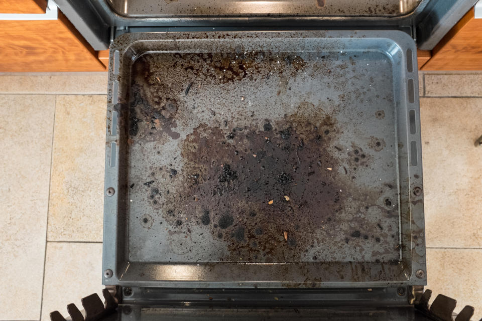 A photo of a dirty kitchen oven from above.