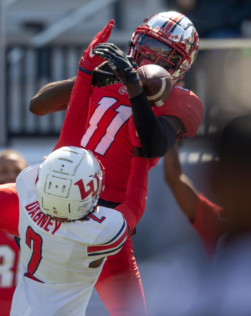 Western Kentucky University wide receiver Craig Burt, Jr. goes up high to catch a touchdown pass over Liberty University cornerback Emanuel Dabney late in the fourth quarter during an NCAA football game on Saturday, Sept. 19, 2020, in Bowling Green, KY. WKU's comeback bid came up short, as Liberty defeated WKU 30-24.