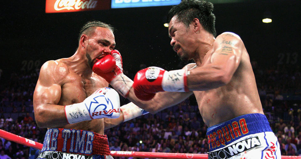 Filipino boxer Manny Pacquiao (R) slams a right to the face of US boxer Keith Thurman  during their WBA super world welterweight title fight at the MGM Grand Garden Arena on July 20, 2019 in Las Vegas, Nevada. - Pacquiao won a 12 round split decision. (Photo by John Gurzinski / AFP)        (Photo credit should read JOHN GURZINSKI/AFP/Getty Images)