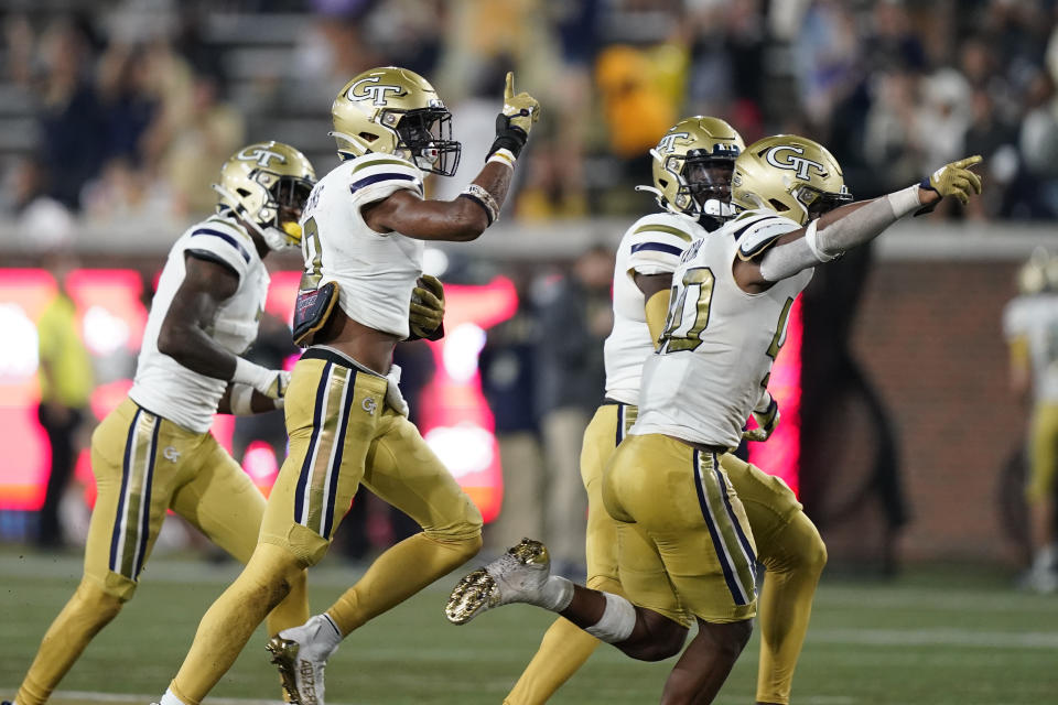 Georgia Tech defensive back Myles Sims, second from left, and teammates celebrate after he intercepted the ball against Western Carolina in the first half during an NCAA college football game, Saturday, Sept. 10, 2022, in Atlanta. (AP Photo/Brynn Anderson)