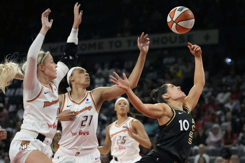 Phoenix Mercury guard Sophie Cunningham, left, fouls Las Vegas Aces guard Kelsey Plum (10) during the first half in Game 1 of a WNBA basketball first-round playoff series Wednesday, Aug. 17, 2022, in Las Vegas. (AP Photo/John Locher)