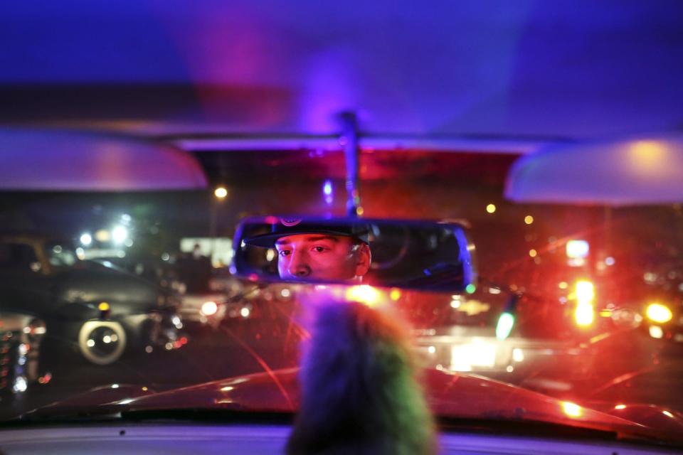 Lucas Lepins rides around the Orchard Hardware parking lot with other lowriders before setting out on a cruise in Pasadena.