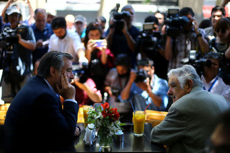 Chilean presidential candidate Alejandro Guillier meets with Uruguayan former president Jose Mujica as part of a campaign rally in Santiago, Chile December 14, 2017. REUTERS/Ivan Alvarado