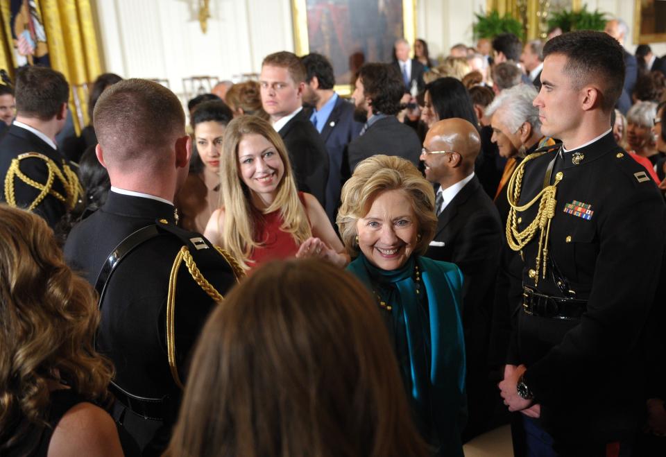 Former U.S. secretary of state Hillary Clinton (R), her daughter Chelsea Clinton (2nd R) and Clinton personal aide Huma Abedin (behind) make their way from the East Room following the Medal of Freedom presentation ceremony at the White House on November 20, 2013 in Washington, DC. The Medal of Freedom is the country's highest civilian honor.  (Photo credit should read MANDEL NGAN/AFP/Getty Images)