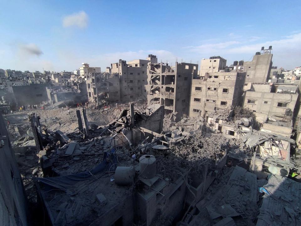 Palestinians search for casualties at the site of Israeli strikes on houses in Jabalia refugee camp in the northern Gaza Strip on Tuesday (REUTERS)