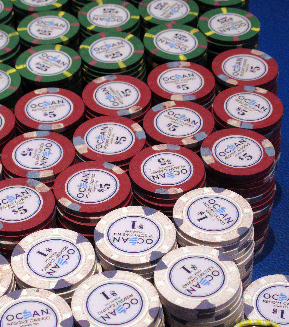 In this June 18, 2019 photo gambling chips sit on a table at the Ocean Casino Resort in Atlantic City, N.J. New Jersey's casinos won nearly $3.3 billion from gamblers in 2019, the first time since 2012 that the Atlantic City gambling halls had won more than $3 billion, according to figures released Tuesday, Jan. 14, 2020, by the New Jersey Division of Gaming Enforcement. (AP Photo/Wayne Parry)