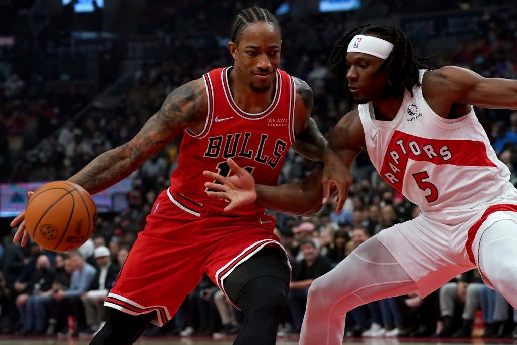 Chicago Bulls forward DeMar DeRozan drives to the net as Toronto Raptors forward Precious Achiuwa defends (Nathan Denette/The Canadian Press via AP) (AP)