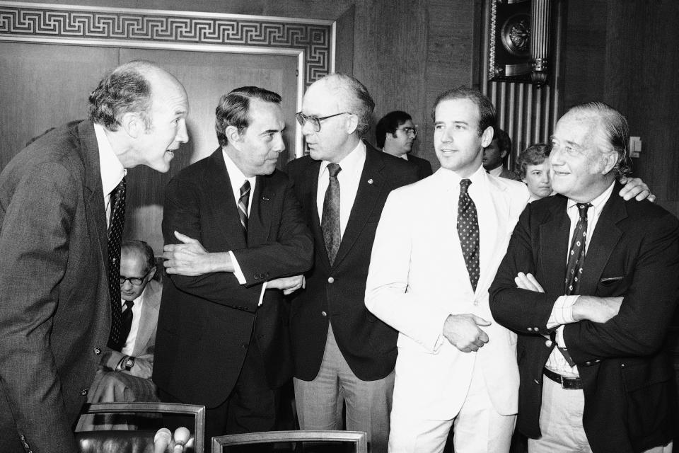 Members of the Senate Judiciary Committee, including from left, Sen. Alan Simpson, R-Wyo., Sen. Robert Dole, R-Kans. and Sen. Patrick Leahy, D-Vt., Sen. Joe Biden D-Del.., confer prior to voting to recommend the nomination of Supreme Court Nominee Sandra Day O'Connor, to the full Senate for confirmation, on Sept. 15, 1981. (Ira Schwarz / AP)