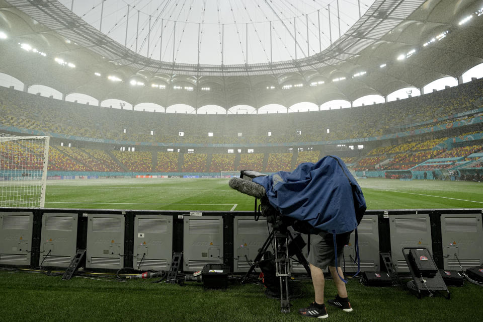 Heavy rain falls before Austria's training session at the National Arena stadium in Bucharest, Romania, Saturday, June 12, 2021, the day before their first match against North Macedonia. (AP Photo/Vadim Ghirda)