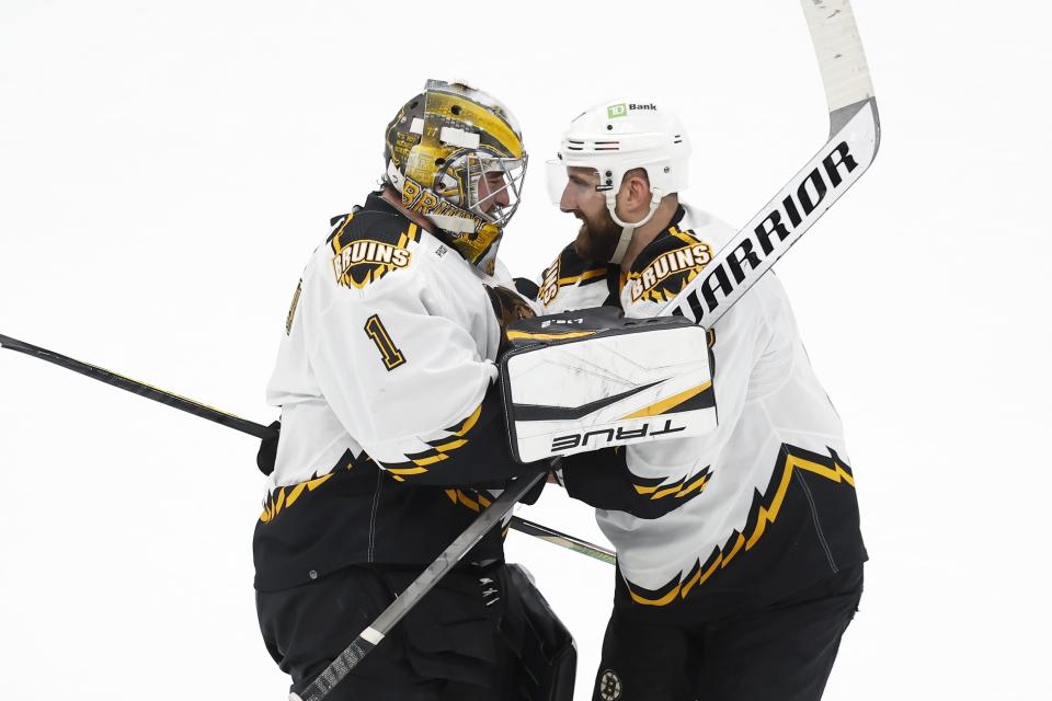 Boston Bruins' Nick Foligno celebrates with Jeremy Swayman (1) after defeating the Carolina Hurricanes in overtime during an NHL hockey game, Friday, Nov. 25, 2022, in Boston. (AP Photo/Michael Dwyer)