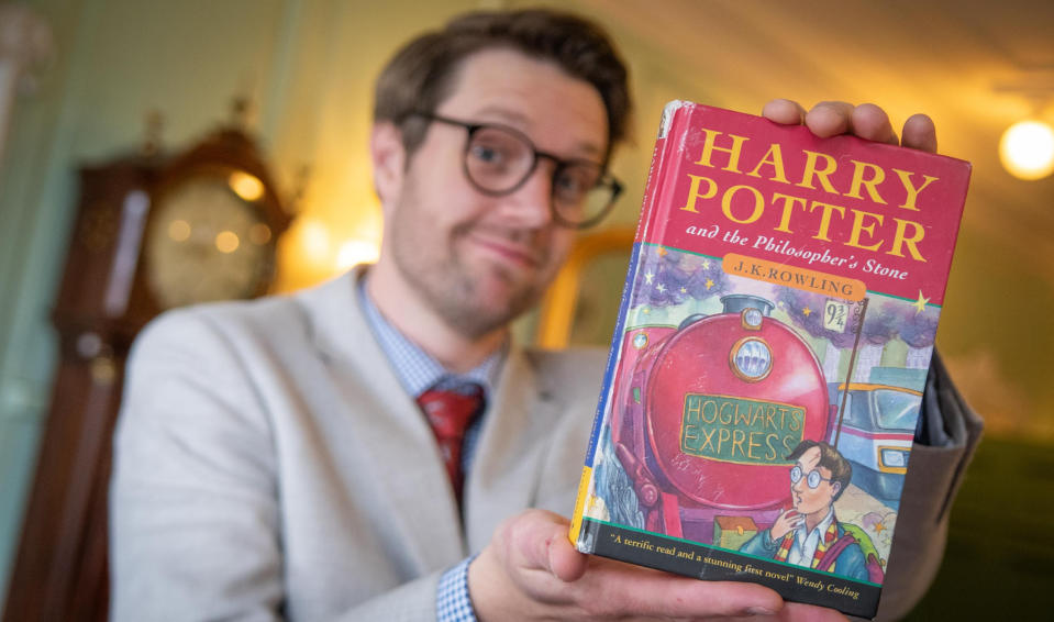 Hansons Auctioneers of Jim Spencer with the first edition Harry Potter book, Harry Potter and the Philosopher's Stone, which was purchased privately for more than $50,000.