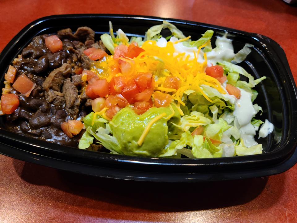 steak power bowl from taco bell resting on a red counter