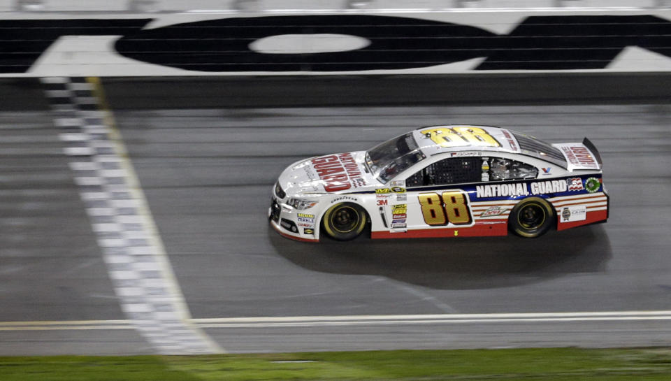 Dale Earnhardt Jr. (88) races to the finish line to win the NASCAR Daytona 500 Sprint Cup series auto race at Daytona International Speedway in Daytona Beach, Fla., Sunday, Feb. 23, 2014. (AP Photo/Chuck Burton)