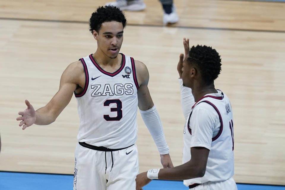 Gonzaga guard Joel Ayayi, right, celebrates with teammate guard Andrew Nembhard (3) after making a basket during the first half of a men's Final Four NCAA college basketball tournament semifinal game against UCLA, Saturday, April 3, 2021, at Lucas Oil Stadium in Indianapolis. (AP Photo/Darron Cummings)