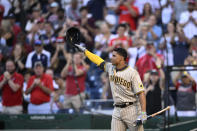 San Diego Padres' Juan Soto doffs his batting helmet to the crowd before his at-bat during the first inning of the team's baseball game against the Washington Nationals, Friday, Aug. 12, 2022, in Washington. (AP Photo/Nick Wass)