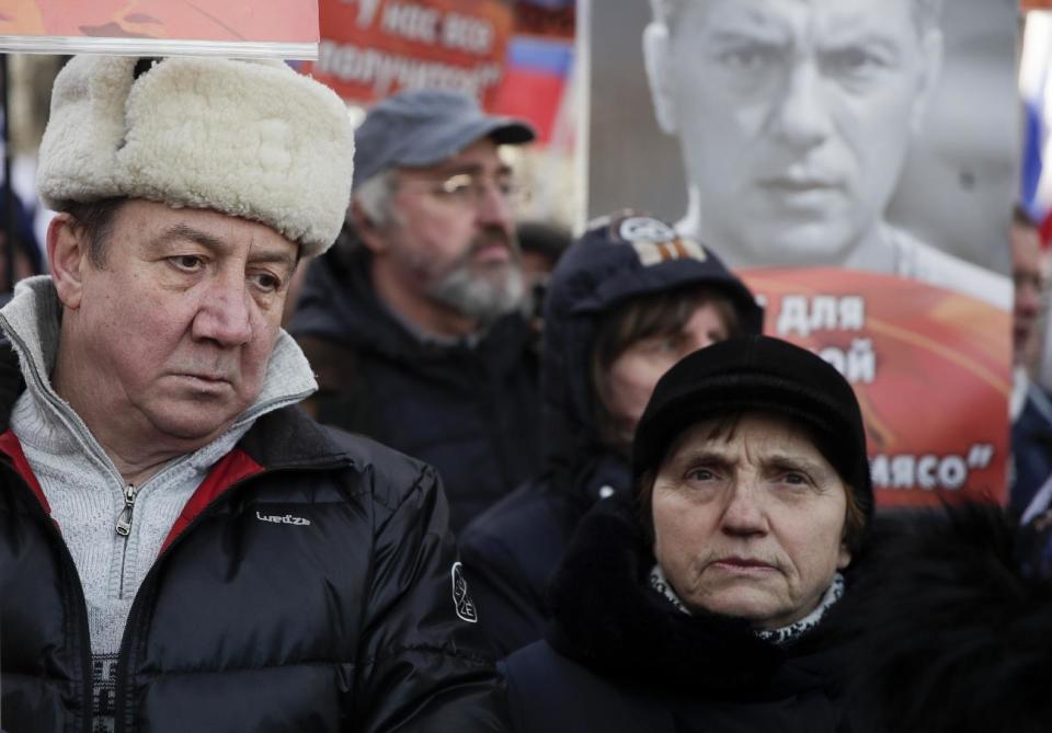 People take part in a march in memory of opposition leader Boris Nemtsov in Moscow, Russia, Sunday, Feb. 26, 2017. Thousands of Russians take to the streets of downtown Moscow to mark two years since Nemtsov was gunned down outside the Kremlin. (AP Photo/Ivan Sekretarev)
