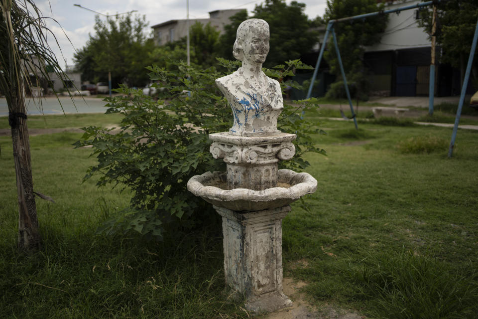 A battered monument depicting the late iconic first lady Eva "Evita" Peron, stands in a public square in the Puerta 8 neighborhood, a suburb north of Buenos Aires, Argentina, Friday, Feb. 4, 2022, where police say contaminated cocaine may have been sold. A batch of toxic cocaine has killed at least 23 people and hospitalized many more in Argentina, according to police. (AP Photo/Rodrigo Abd)