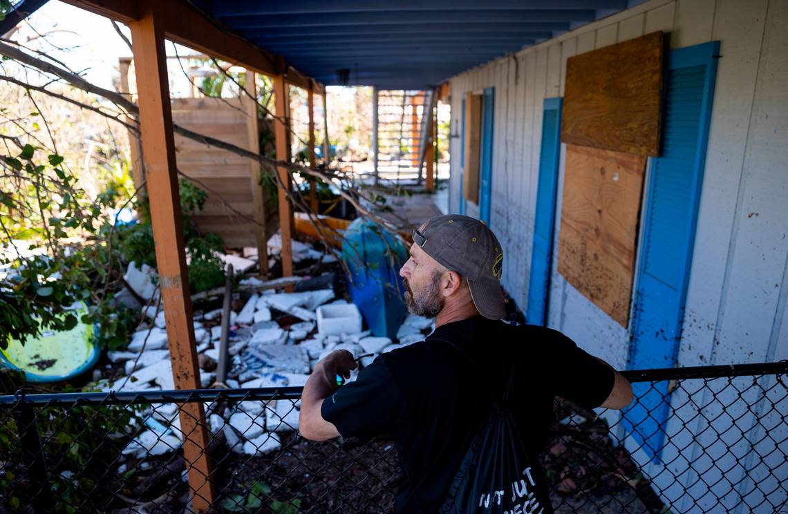 Mike Romeo, 53, surveys damage at his St. James City home on Friday, Sept. 30, 2022, in Pine Island, Fla. Romeo has lived on Pine Island for years. Hurricane Ian made landfall on the coast of South West Florida as a category 4 storm Tuesday afternoon leaving areas affected with flooded streets, downed trees and scattered debris.