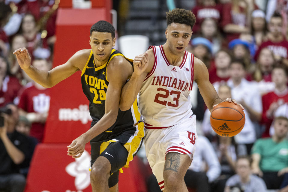 Iowa forward Kris Murray (24) makes contact with Indiana forward Trayce Jackson-Davis (23), who was bringing the ball up court during the second half of an NCAA college basketball game Tuesday, Feb. 28, 2023, in Bloomington, Ind. (AP Photo/Doug McSchooler)