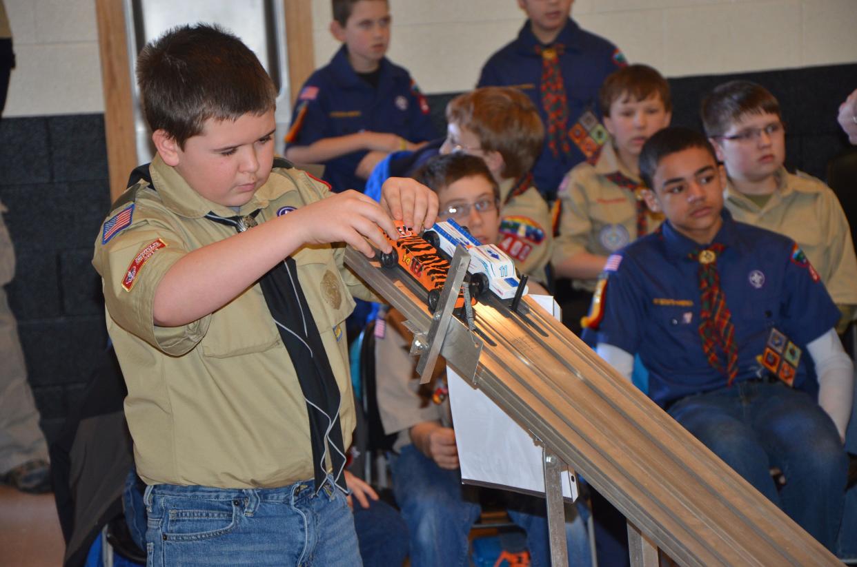 A Boy Scout participates in a Pinewood Derby championship at Gibsonburg Middle School in 2015. Boy Scout Day is observed on Feb. 8.