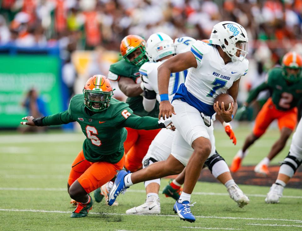 University of West Florida quarterback Peewee Jarrett (7) escapes a Florida A&M University defender during the Argos' 31-10 loss at Ken Riley Field at Bragg Memorial Stadium on Saturday, Sept. 16, 2023.