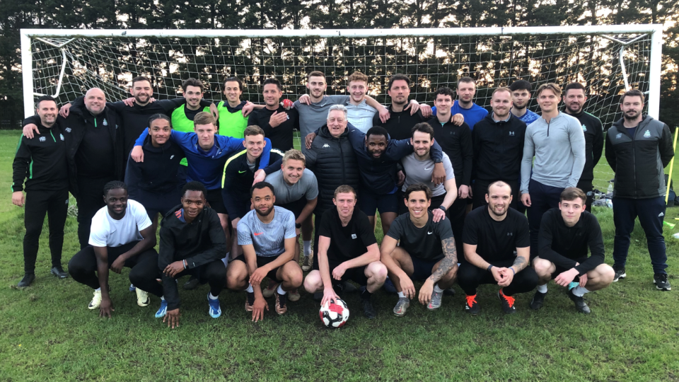 The Great Wakering Rovers squad pose in front of a goal