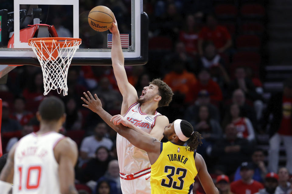 Houston Rockets center Alperen Sengun dunks against Indiana Pacers center Myles Turner (33) during the first half of an NBA basketball game Tuesday, Dec. 26, 2023, in Houston. (AP Photo/Michael Wyke)