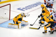 New York Islanders' Josh Bailey, far right, puts the winning overtime goal behind Pittsburgh Penguins goaltender Tristan Jarry, left, with Penguins' Evgeni Malkin (71) and Mike Matheson (5) defending in Game 5 of an NHL hockey Stanley Cup first-round playoff series in Pittsburgh, Monday, May 24, 2021. (AP Photo/Gene J. Puskar)