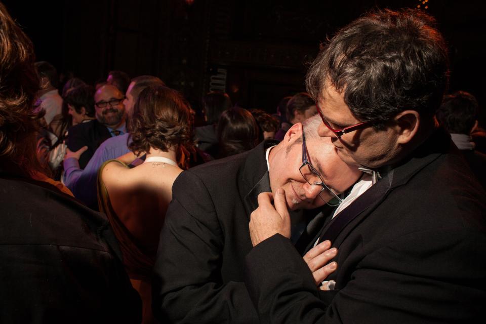 SEATTLE, WA - DECEMBER 9: Paul Beppler (R) and his husband Terry Gilbert participate in a group first dance at "A Wedding Reception for All," which was attended by hundreds and held at the Paramount Theatre on December 9, 2012 in Seattle, Washington. The two were married today after 12 years together. Today is the first day that same-sex couples can legally wed in Washington state. (Photo by David Ryder/Getty Images)