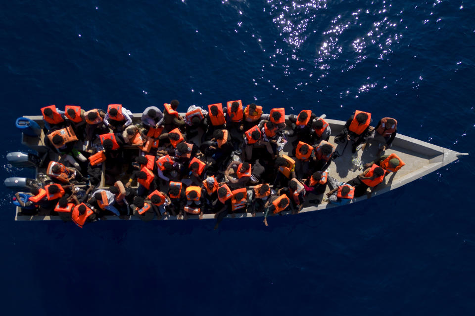 FILE - Migrants from Eritrea, Libya and Sudan sail a wooden boat before being assisted by aid workers of the Spanish NGO Open Arms, in the Mediterranean sea, about 30 miles north of Libya, Saturday, June 17, 2023. Ministers from Germany and France tasked with regulating migration are joining forces to try to curb deaths on dangerous routes across the Mediterranean Sea. The interior ministers are traveling Sunday for talks with the president and their counterpart in Tunisia, a major North African stepping stone for migrants trying to reach Europe at risk of their lives. (AP Photo/Joan Mateu Parra, File)